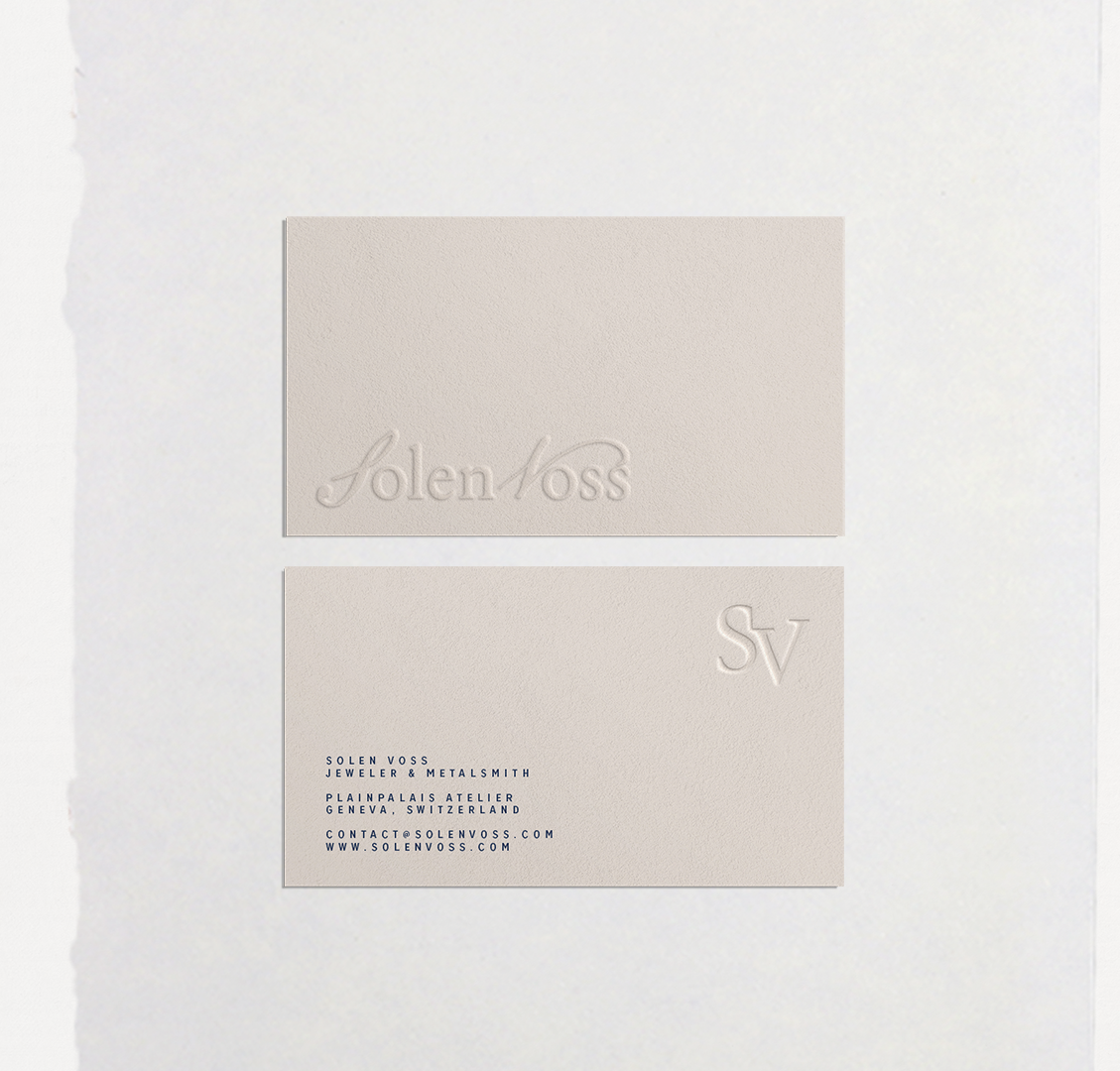 Business cards and stationery on a pale surface